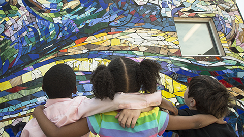 children looking at mural